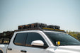 Roof Rack Light Mount for the 4th Gen Toyota Tacoma Roof Rack with storage boxes against a clear sky