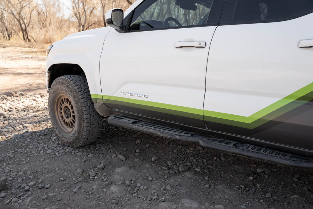 Tacoma side step with light dust, showing the spiky grip of the top plates.