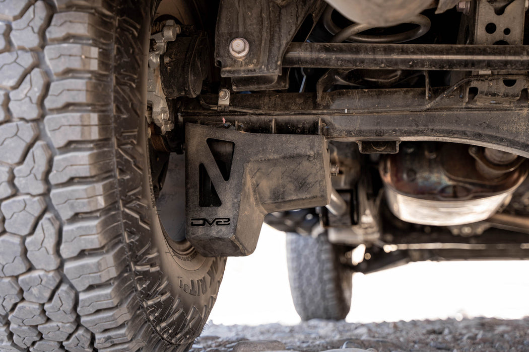 Close-up of dirt and mud on the rear shock skid plate.