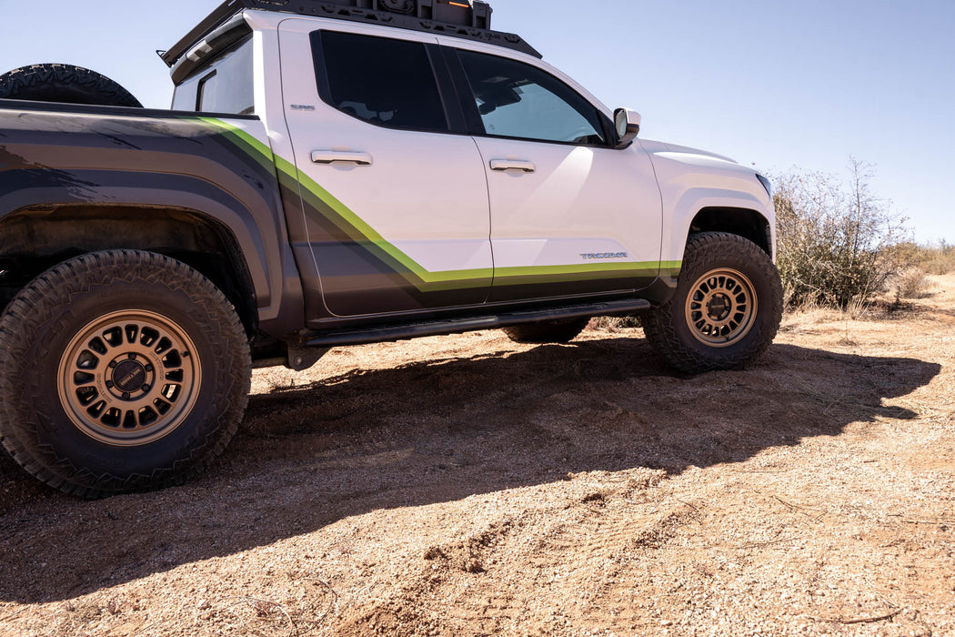 Tacoma on dirt path with high clearance steps.