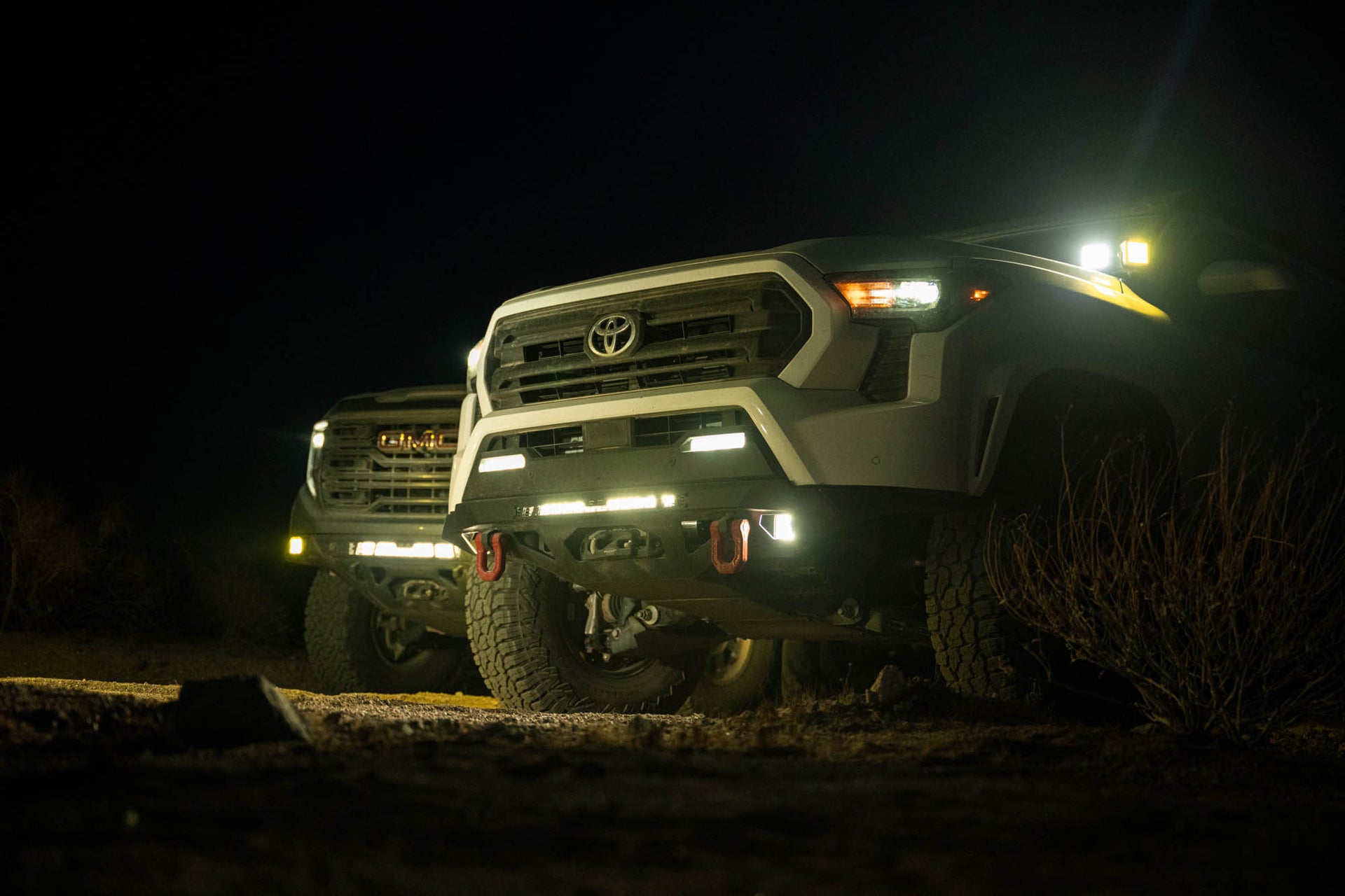 Spec Series Front Bumper on the 4th Gen Toyota Tacoma on a dirt road at night with all lights on.