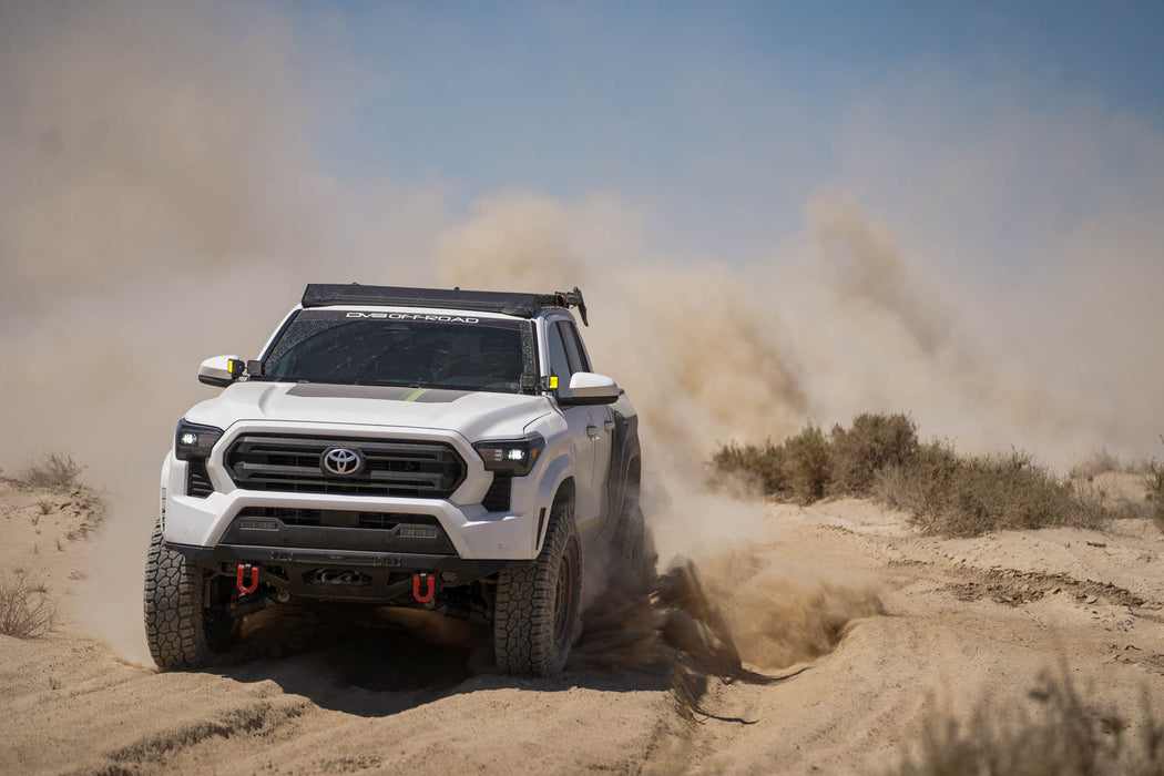 Spec Series Front Bumper on the 4th Gen Toyota Tacoma driving high speed through loose dirt.