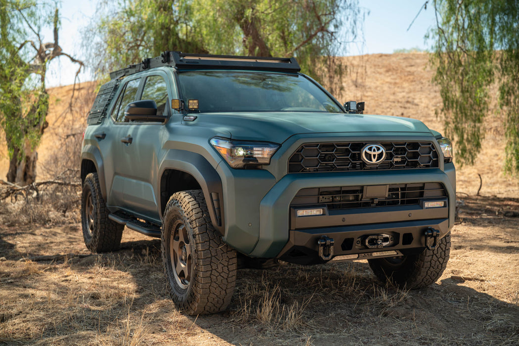 6th Gen Toyota 4Runner Centric Winch Front Bumper, in a desert setting with trees in the background