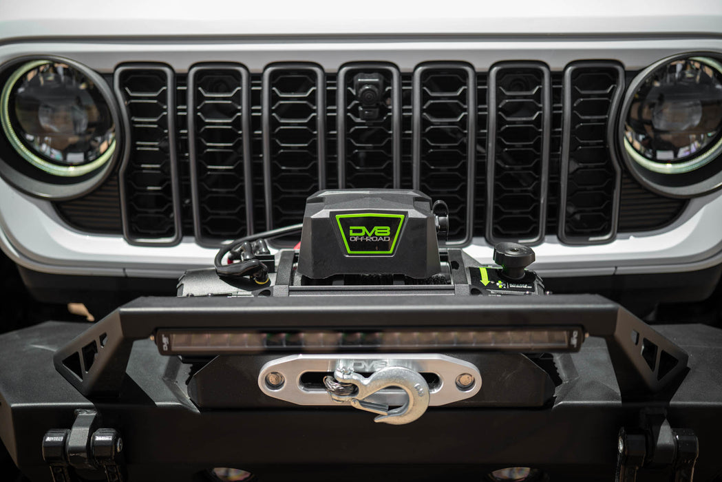 Close-up of a vehicle grille with a DV8 Offroad bumper and winch.
