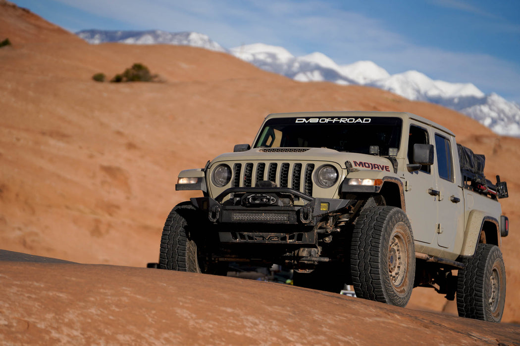Jeep Gladiator on a rock-crawling trail with mountains in the background