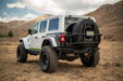 White Jeep Wrangler with 2018-2025 Jeep Wrangler JL Body Mounted Tire Carrier in a desert landscape