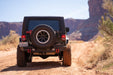 Jeep JK on a dirt road with desert landscape in the background
