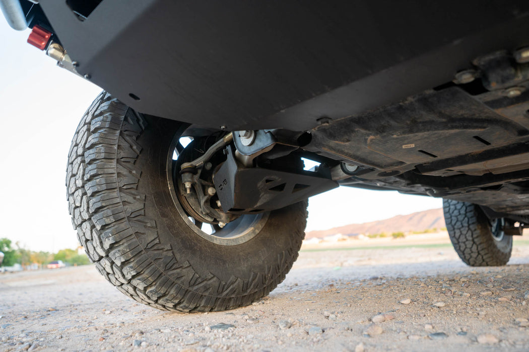 Close-up of bronco with the A-Arm skid plate on a gravel surface.
