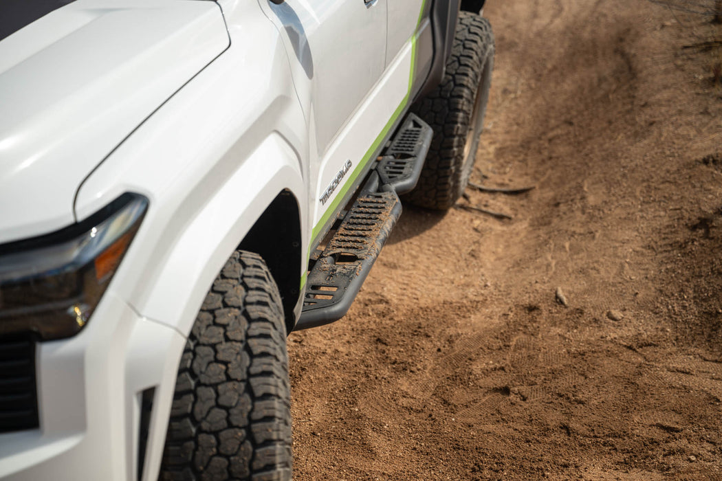 Off-road side steps covered with damp dirt.